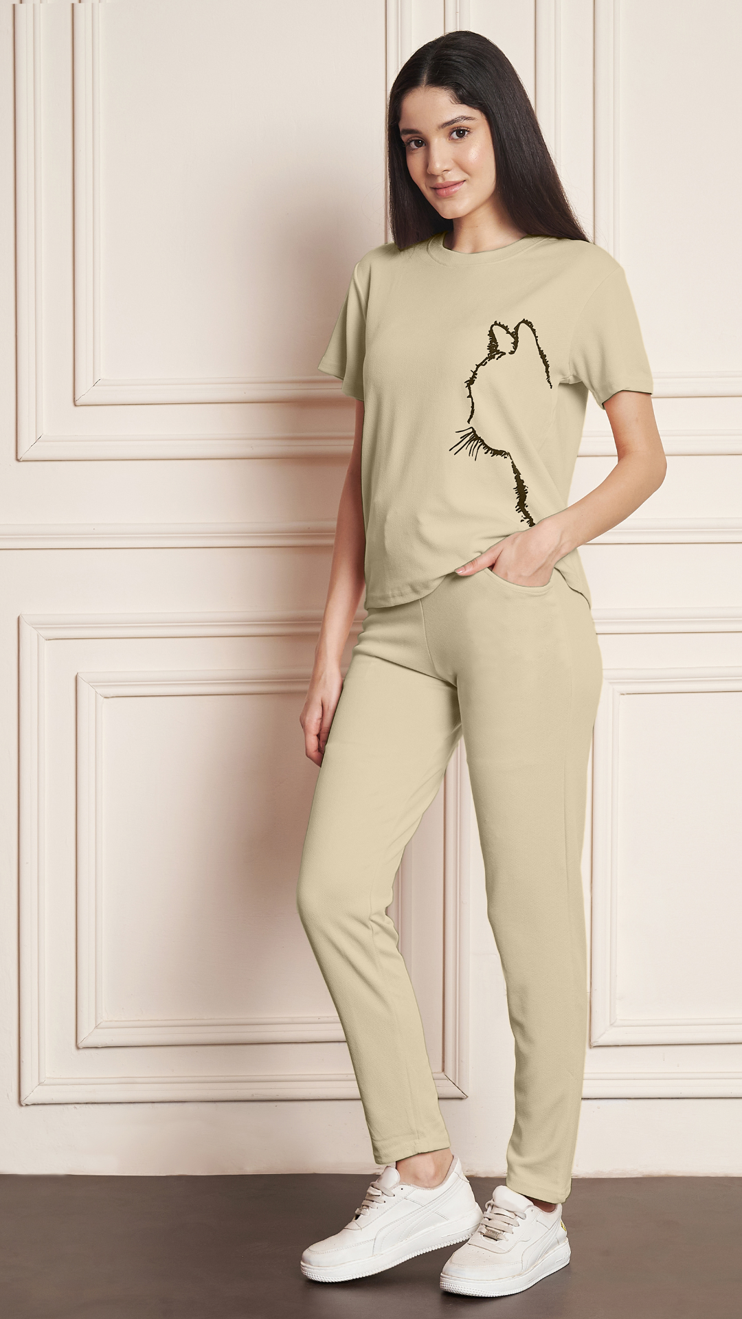 Women's Beige Lycra blend tracksuit with a black cat print on the t-shirt.
• A woman modeling a comfortable grey tracksuit with an animal print design, perfect for loungewear or casual outfits.
• Full-length view of a Beige tracksuit featuring a unique cat graphic on the top and matching bottoms.
