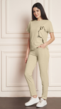 Women's Beige Lycra blend tracksuit with a black cat print on the t-shirt.
• A woman modeling a comfortable grey tracksuit with an animal print design, perfect for loungewear or casual outfits.
• Full-length view of a Beige tracksuit featuring a unique cat graphic on the top and matching bottoms.